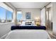 Comfortable bedroom features a full bed, natural light, and a sliding barn door at 4265 E Iliff Ave # 1, Denver, CO 80222