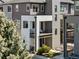 Modern townhome featuring multi-story balconies, a stylish design, and landscaped front yard for curb appeal at 4265 E Iliff Ave # 1, Denver, CO 80222