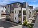 Modern townhome featuring multi-story balconies and attached garages, designed for contemporary living and convenience at 4265 E Iliff Ave # 1, Denver, CO 80222