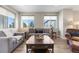 Cozy living room featuring plush sofas, large windows, and a rustic coffee table at 4265 E Iliff Ave # 1, Denver, CO 80222