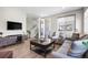 Comfortable living room with a large TV, wood floors, and access to an outdoor patio at 4265 E Iliff Ave # 1, Denver, CO 80222