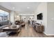 Open living space with kitchen, dining, and entertainment area including a large TV at 4265 E Iliff Ave # 1, Denver, CO 80222