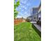 Well-maintained backyard with lush green grass, wooden fence, and outdoor grill area, ideal for outdoor enjoyment at 5799 Boston St, Denver, CO 80238