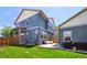 Spacious backyard featuring a patio area, green lawn, and privacy fence, perfect for outdoor activities and gatherings at 5799 Boston St, Denver, CO 80238