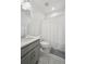 Clean bathroom featuring gray vanity with white countertop, white toilet and shower with tiled walls at 5799 Boston St, Denver, CO 80238