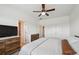 Spacious bedroom features large dresser and walk-in closet, with ceiling fan, and soft carpeting at 5799 Boston St, Denver, CO 80238