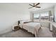 Cozy bedroom with neutral tones, a ceiling fan, large windows, and ample natural light at 5799 Boston St, Denver, CO 80238