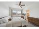 Inviting bedroom with neutral decor, ceiling fan, and a large window letting in ample natural light at 5799 Boston St, Denver, CO 80238