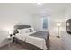 Comfortable bedroom with a queen-sized bed, soft grey palette, and natural light, creating a serene atmosphere at 5799 Boston St, Denver, CO 80238