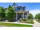 Charming two-story home with a covered front porch and beautifully landscaped front yard at 5799 Boston St, Denver, CO 80238