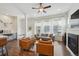 Open-concept living area with hardwood floors, fireplace, and plenty of seating at 5799 Boston St, Denver, CO 80238