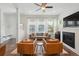Bright living room with large windows, hardwood floors, and a modern fireplace at 5799 Boston St, Denver, CO 80238