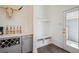 Stylish mudroom featuring built-in bench, storage, coat hooks, and an adjacent wine and coffee bar at 5799 Boston St, Denver, CO 80238