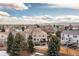 An aerial view shows the house, back yard with patio and upper deck, as well as the neighborhood at 3001 White Oak Trl, Highlands Ranch, CO 80129