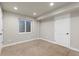 Bright basement showcasing painted walls, recessed lighting, and a door leading to additional storage at 3001 White Oak Trl, Highlands Ranch, CO 80129