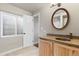 Bathroom featuring stylish vanity with a copper sink, an ornate mirror, and natural light at 3001 White Oak Trl, Highlands Ranch, CO 80129