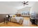 Spacious bedroom with a large window, ceiling fan, and ample natural light creating a comfortable ambiance at 3001 White Oak Trl, Highlands Ranch, CO 80129