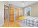 Comfortable bedroom with closet, ceiling fan, and plantation shutters overlooking a large window at 3001 White Oak Trl, Highlands Ranch, CO 80129