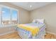 Bright bedroom with a cozy bed, a ceiling fan, and plantation shutters allowing ample natural light at 3001 White Oak Trl, Highlands Ranch, CO 80129