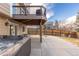 Backyard patio with a hot tub and an upper deck, ideal for outdoor relaxation and entertaining at 3001 White Oak Trl, Highlands Ranch, CO 80129