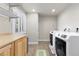 Laundry room with modern washer and dryer, ample counter space, and a bright window at 3001 White Oak Trl, Highlands Ranch, CO 80129