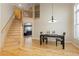 Open floor plan with high ceilings, staircase, and natural light fills this dining and living area at 3001 White Oak Trl, Highlands Ranch, CO 80129