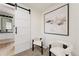 Bedroom decor featuring two accent chairs, modern art, and a view into the ensuite bathroom at 1361 W Custer Pl, Denver, CO 80223