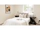 Cozy bedroom featuring a large window, decorative pillows, and modern side tables at 1361 W Custer Pl, Denver, CO 80223
