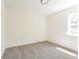 This bright and airy bedroom features neutral tones, a soft carpet, and a sunny window at 1361 W Custer Pl, Denver, CO 80223