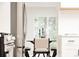 Bright dining area with a modern table, chairs, and natural light from the large window at 1361 W Custer Pl, Denver, CO 80223