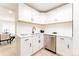 Bright, modern kitchen with white cabinets, subway tile backsplash, and stainless steel appliances at 1361 W Custer Pl, Denver, CO 80223
