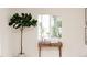 Bright living space featuring a modern console table, houseplant and a large window at 1361 W Custer Pl, Denver, CO 80223
