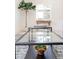 Close up of glass coffee table in a bright living room with view of window at 1361 W Custer Pl, Denver, CO 80223
