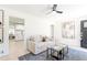 Cozy living room with modern decor, light wood floors and ceiling fan at 1361 W Custer Pl, Denver, CO 80223