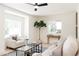 Bright and airy living room with large windows, stylish furniture, and hardwood floors at 1361 W Custer Pl, Denver, CO 80223