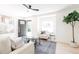 Open living room with modern furniture and abundant natural light from the front door at 1361 W Custer Pl, Denver, CO 80223