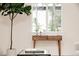 Bright living room with a decorative table, large window, and a stylish indoor tree for a touch of nature at 1361 W Custer Pl, Denver, CO 80223