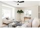 Open living room featuring leafy tree, light, and comfortable furniture at 1361 W Custer Pl, Denver, CO 80223