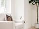 Cozy armchair by a window in a naturally lit living room with minimalist decor and inviting ambiance at 1361 W Custer Pl, Denver, CO 80223