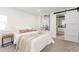 Serene main bedroom with soft textures, a barn door leading to the bathroom, and ample natural light at 1361 W Custer Pl, Denver, CO 80223