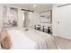 Inviting main bedroom with a calming color palette, barn door to the bathroom, and stylish artwork at 1361 W Custer Pl, Denver, CO 80223