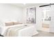 Serene bedroom with soft bedding and modern art, connected to the ensuite bathroom with a sliding barn door at 1361 W Custer Pl, Denver, CO 80223