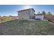 Exterior view of the backyard featuring grass, a shed and the back of the home at 7611 Fernando Rd, Denver, CO 80221