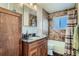 Granite vanity and shower/tub combo with neutral tile work in this bathroom at 7611 Fernando Rd, Denver, CO 80221