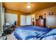 Cozy bedroom featuring a bed, dresser, closet, and a bright, sunny window at 7611 Fernando Rd, Denver, CO 80221