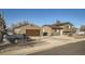 Home's exterior view featuring detached garage, driveway, chain-link fence and partial truck at 7611 Fernando Rd, Denver, CO 80221