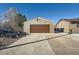 This detached garage features a brown garage door and ample parking space in the driveway at 7611 Fernando Rd, Denver, CO 80221