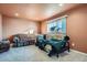 Living area with two sofas, carpet, and a bright window at 7611 Fernando Rd, Denver, CO 80221