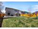 Expansive backyard with well-maintained lawn, patio dining area, and play structure at 5010 Ox Trl, Parker, CO 80134