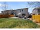 Well-kept backyard with patio, dining set, and ample green space for outdoor activities at 5010 Ox Trl, Parker, CO 80134